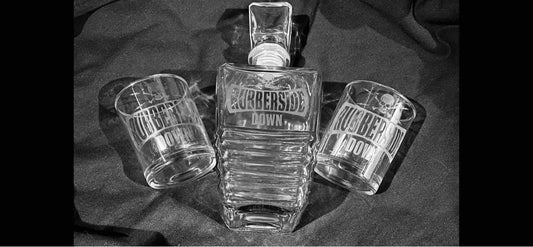 Limited Edition etched Rubber Side Down whisky decantor with two glasses.